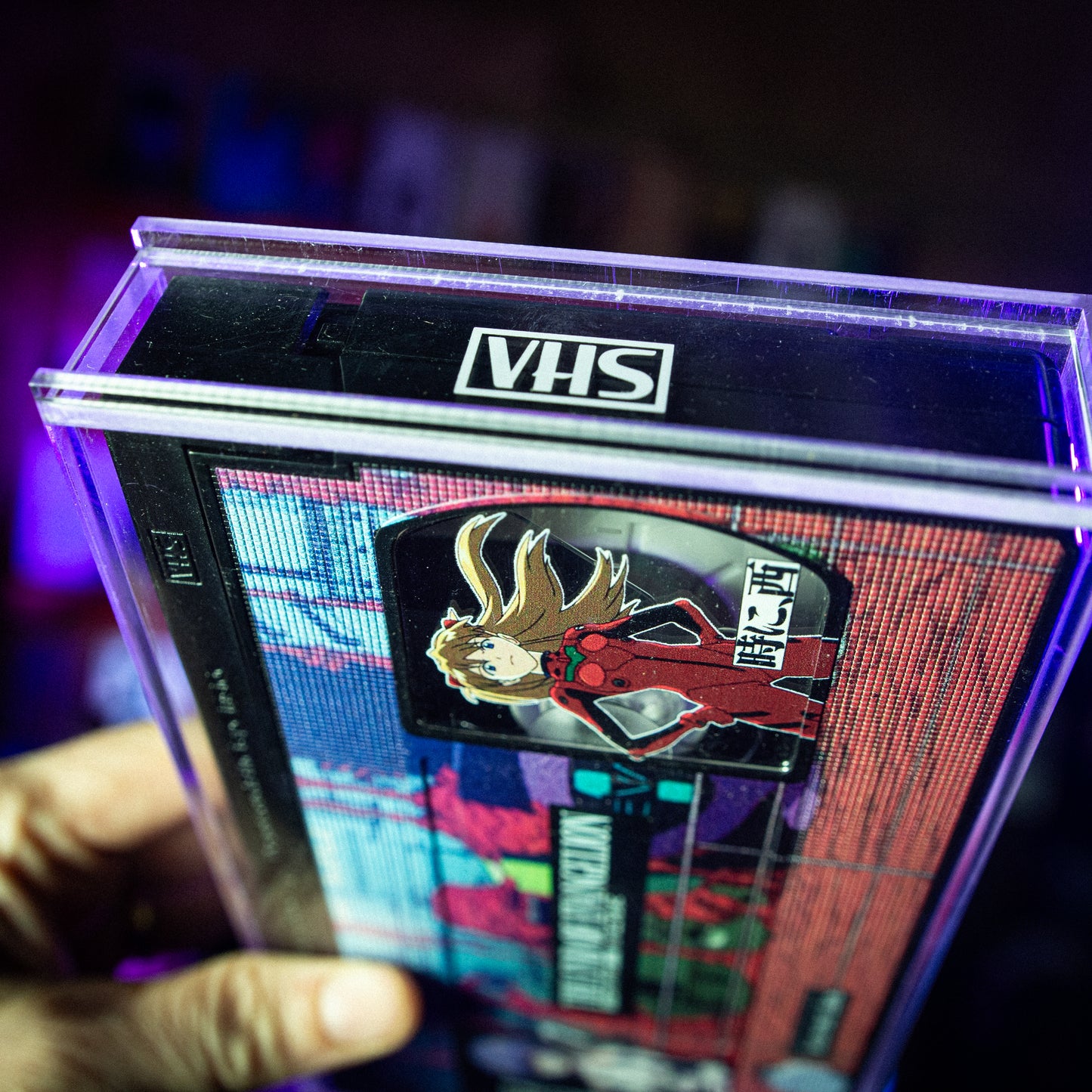 End of Evangelion VHS w/ Acrylic Case Pre-Order — cardboard sleeve — alternate angle of sleeve and tape — VCR Zone