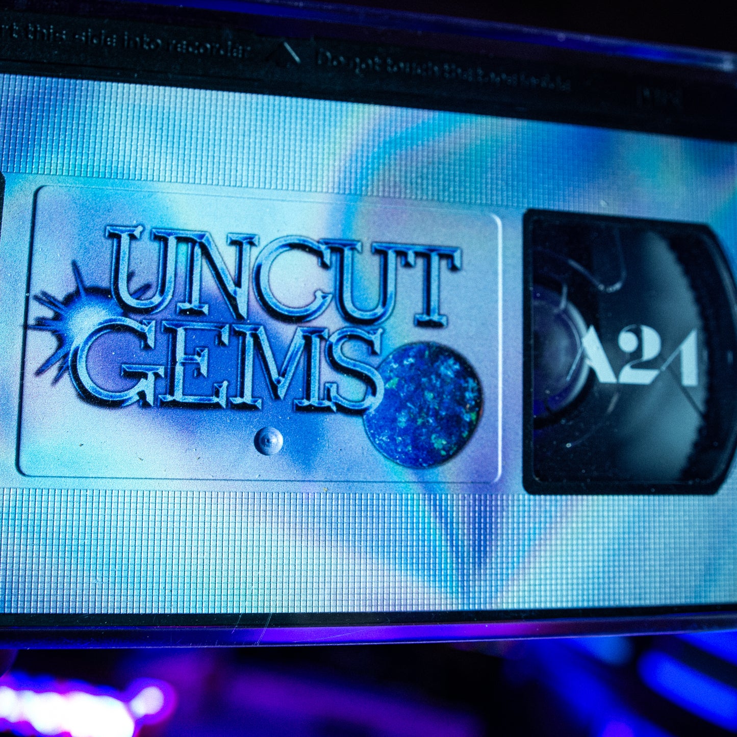 Uncut Gems VHS w/ Acrylic Case Pre-Order — cardboard sleeve — close-up of tape label with sleeve — VCR Zone